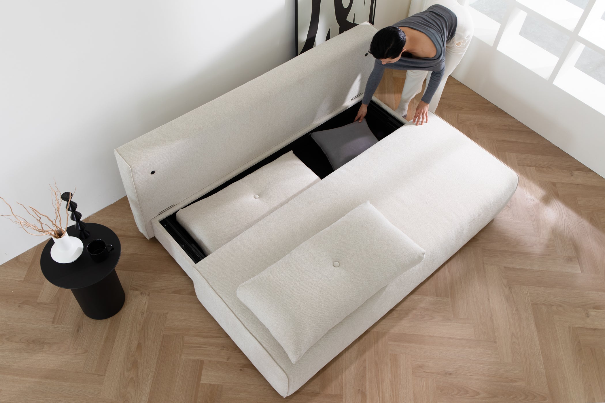DUNCAN Pearl White Lifetyle With Model sofa bed