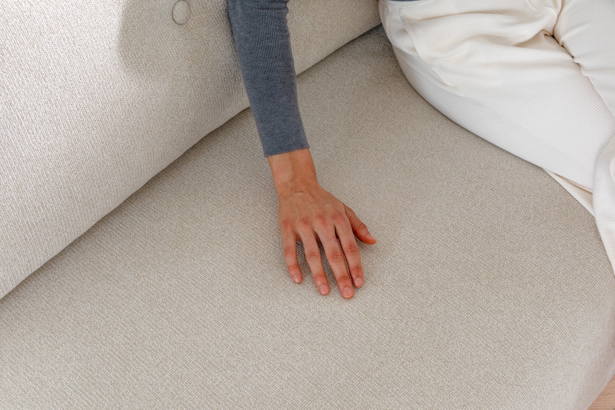 DUNCAN Pearl White Lifetyle With Model sofa bed 